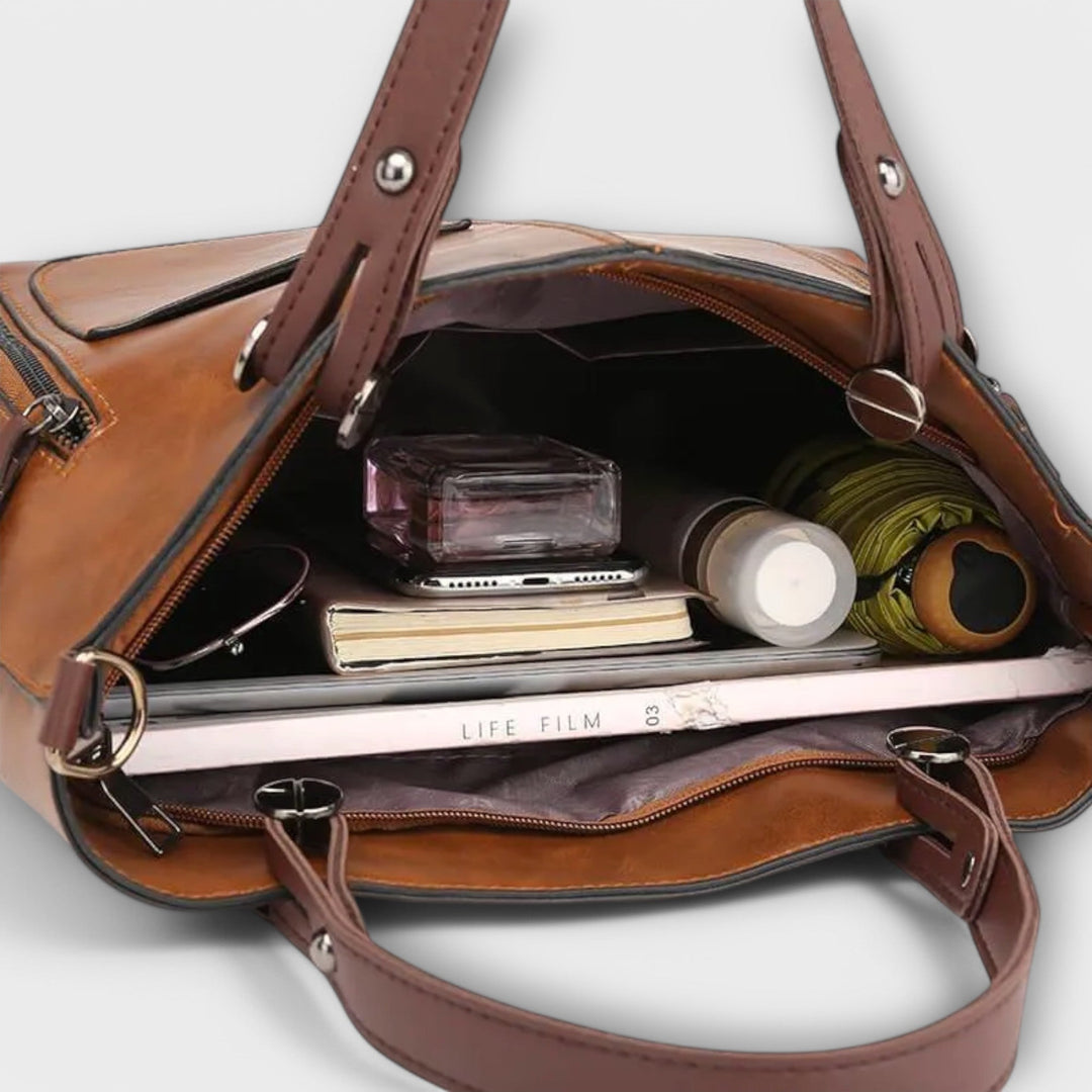 Sac à main femme en cuir gris, un accessoire mode polyvalent. Parfait pour un look professionnel ou décontracté chic.