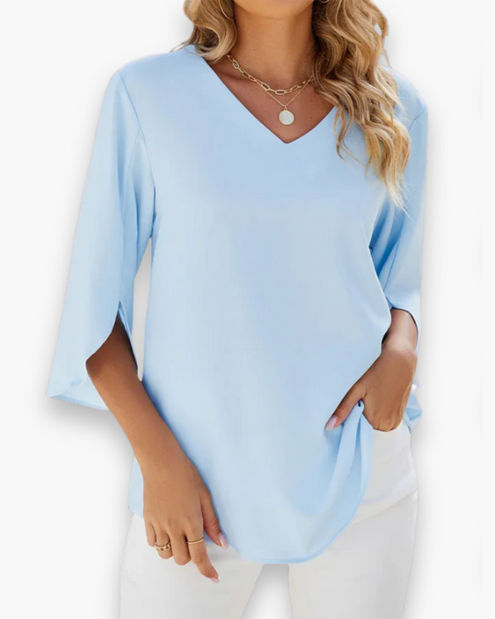 Blouse élégante femme col V chic, parfaite pour le bureau ou une soirée printanière.