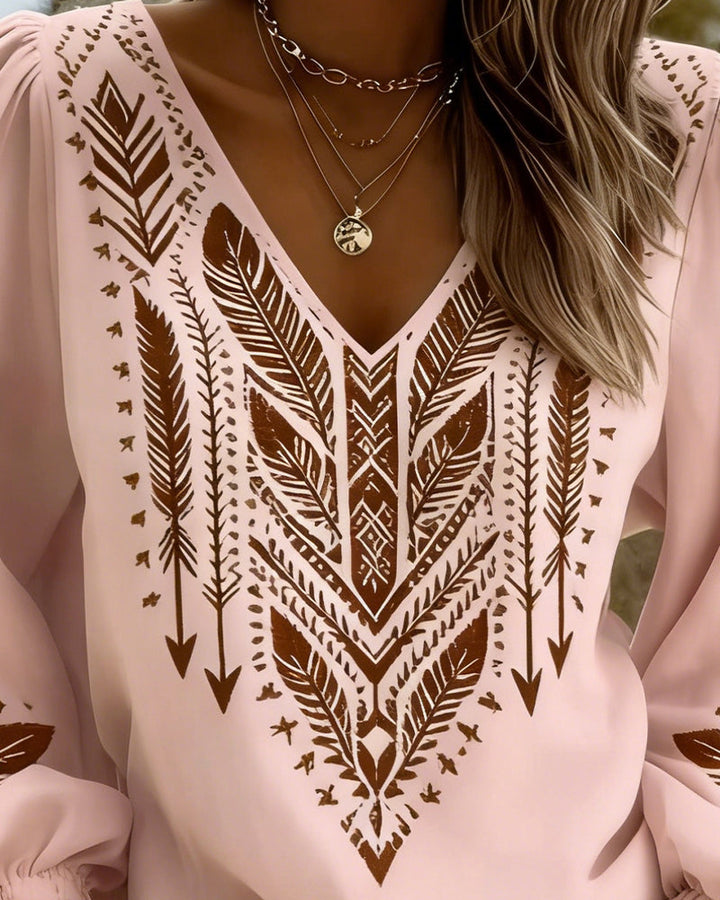Blouse femme élégante à décolleté en V et manches bouffantes. Style bohème chic, idéale pour le printemps-été.