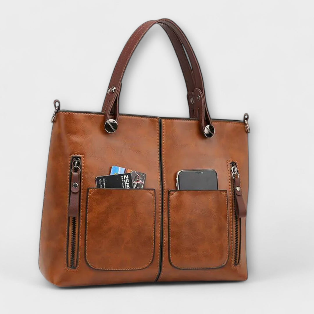 Sac à main femme en cuir gris, design sophistiqué et polyvalent. Idéal pour compléter votre tenue mode.