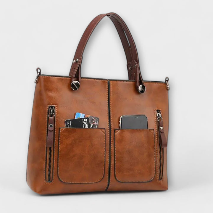 Sac à main femme en cuir gris, design sophistiqué et polyvalent. Idéal pour compléter votre tenue mode.