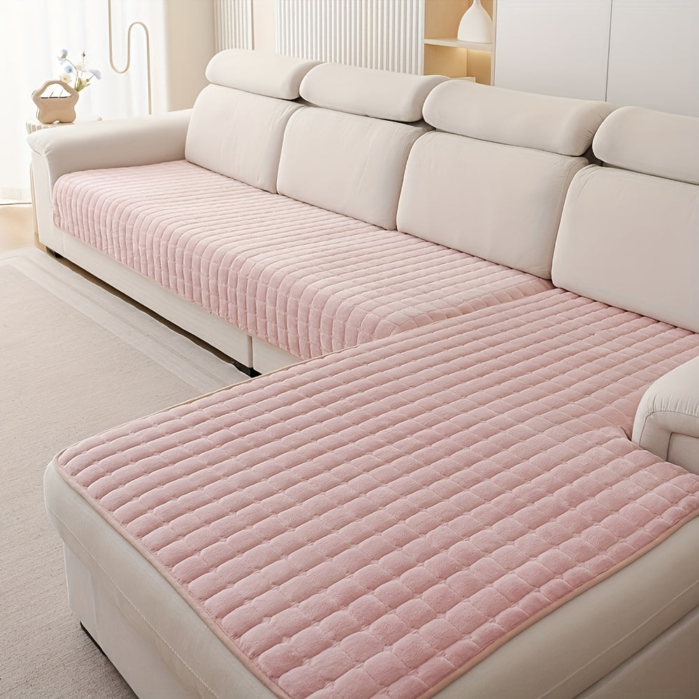 Housse de canapé grise foncée matelassée, offre confort et protection durable contre taches et usure.