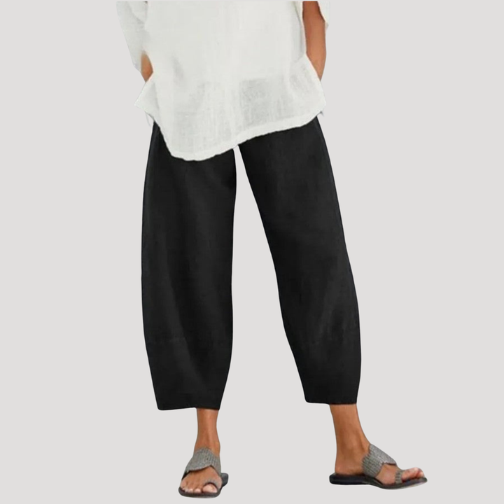 Pantalon femme en lin pur, couleur naturelle. Coupe ample et décontractée avec taille élastique pour l'été. Vêtement essentiel.