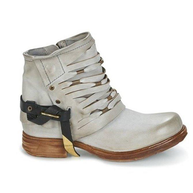 Détail bottines femme rétro élégantes, vue sur le talon bloc et la finition du cuir.