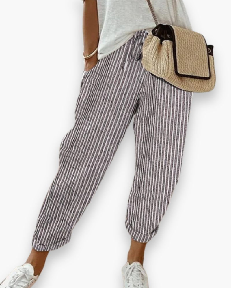 Pantalon d'été femme ample et fluide, idéal pour un confort décontracté. Style moderne et facile à porter.