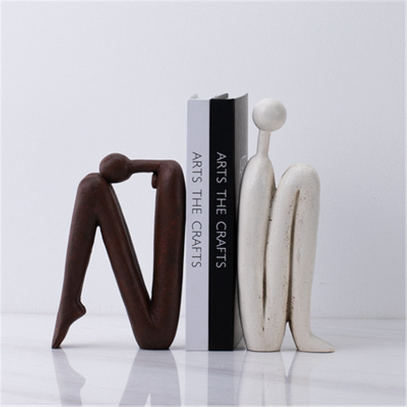Support de livre artistique en métal noir, design élégant pour bureau ou salon moderne, organise vos livres avec style.