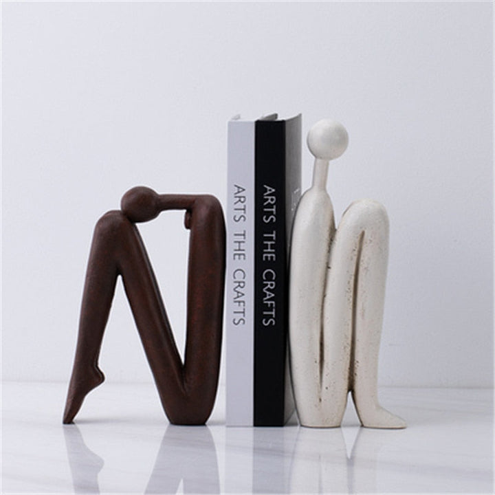 Support de livre artistique en métal noir, design élégant pour bureau ou salon moderne, organise vos livres avec style.