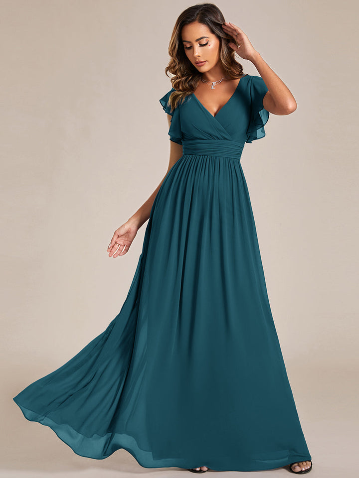 Robe de demoiselle d'honneur élégante, dos ouvert. Fluide et longue pour un mariage d'été raffiné et délicat.
