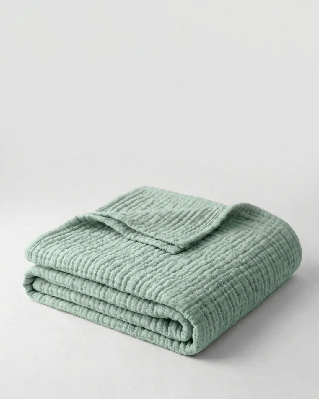 Couverture douce en coton pour la maison, design élégant et naturel, idéale toutes saisons.