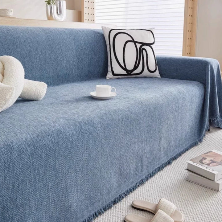 Housse texturée lavable pour canapé, avec pampilles. Protection et embellissement pour tout salon.