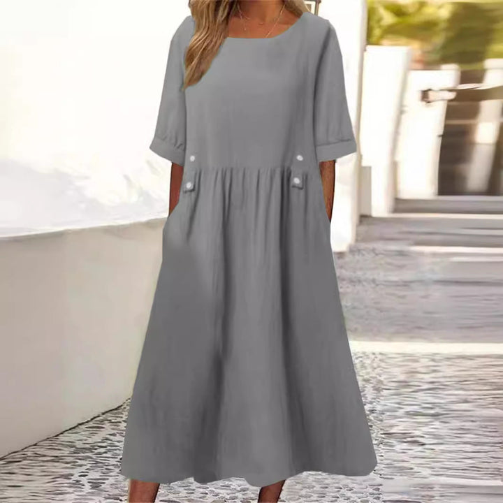 Élégante robe d'été mi-longue pour femme, en coton lin. Col rond, manches courtes pour un confort chic.