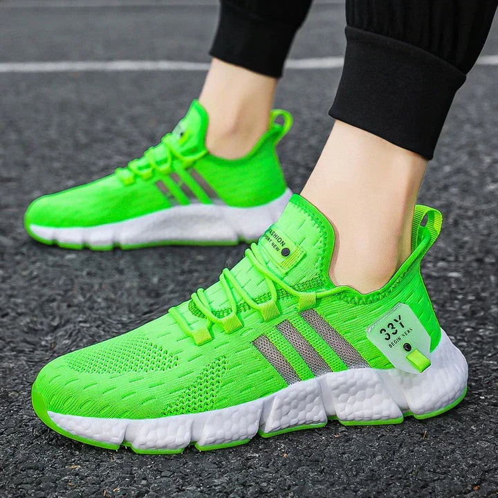 Baskets homme légères et respirantes pour le sport et le quotidien, offrant confort et style urbain. Couleurs : blanc, vert, noir.