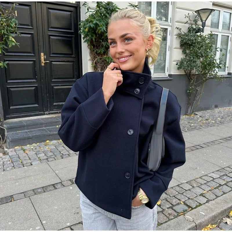 Veste courte femme noire, boutonnage asymétrique unique. Minimaliste et élégante pour la ville.