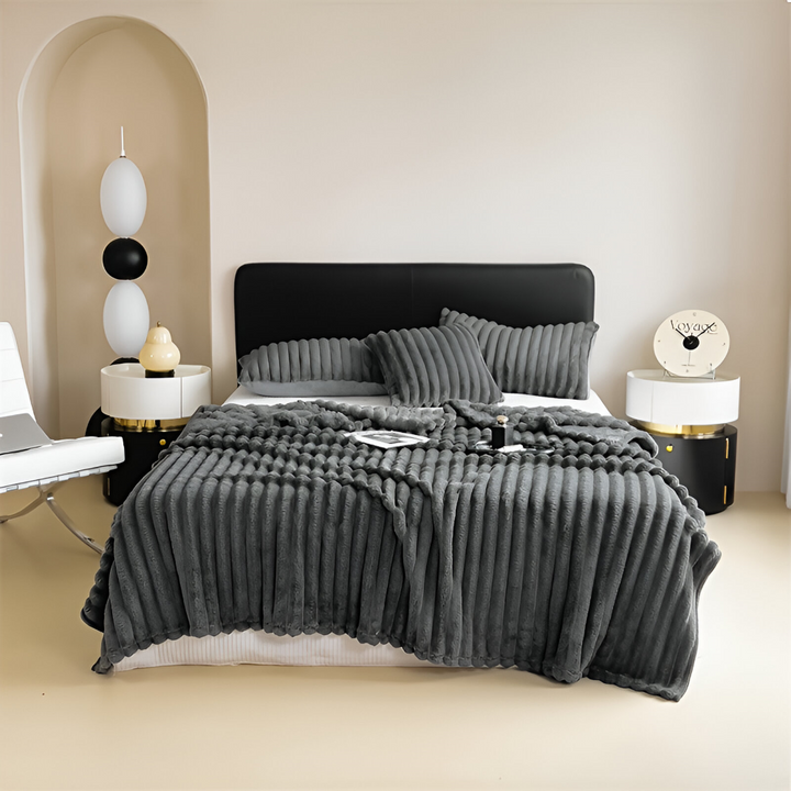 Chaleureux plaid polaire rayé, un accessoire indispensable pour la décoration intérieure moderne.