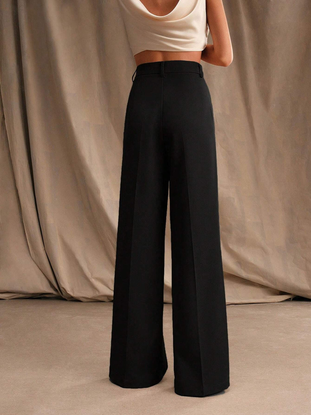 Élégant pantalon femme plissé taille haute, coupe large, idéal pour tenue professionnelle chic.