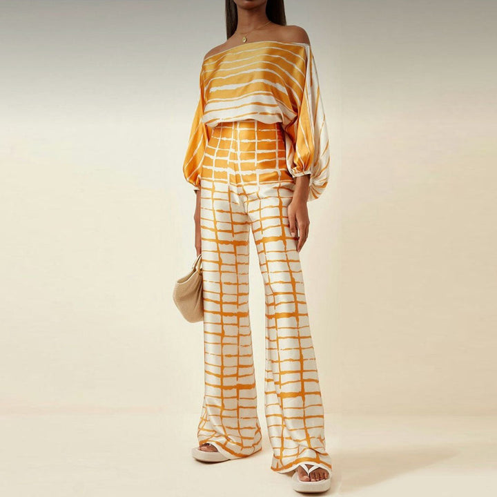 Ensemble femme moderne deux pièces : top épaules dénudées et pantalon large taille haute. Vêtement élégant pour soirée.