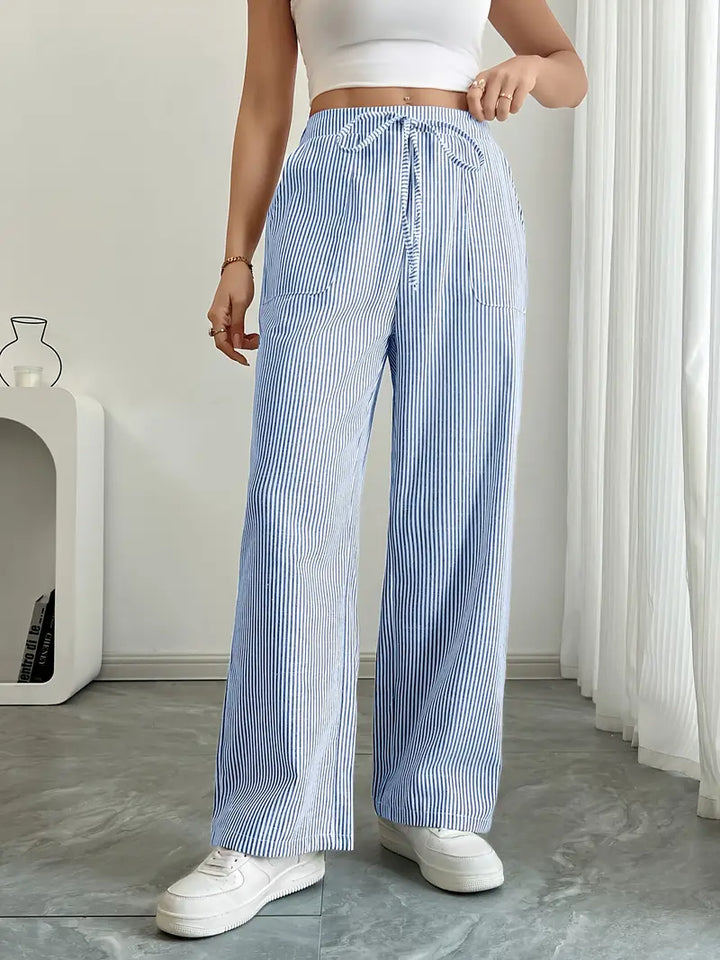 Pantalon femme fluide, rayures verticales, poches pratiques.