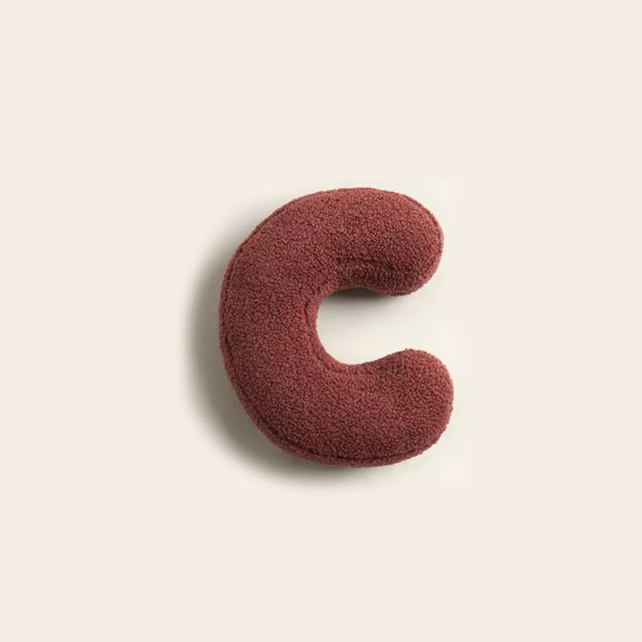 Coussin personnalisé lettre D, idéal pour un intérieur contemporain.