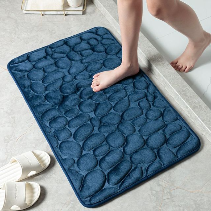 Tapis de bain élégant design pierre dans une salle de bain moderne, en mousse mémoire pour un confort optimal.