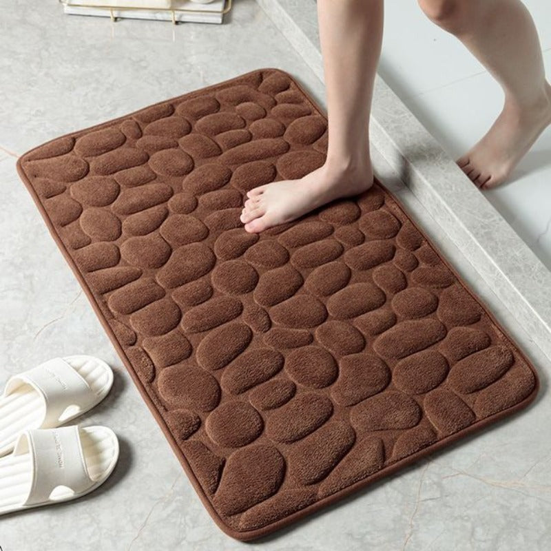 Tapis de bain décoratif effet pierre en mousse mémoire, pour une salle de bain moderne et élégante.