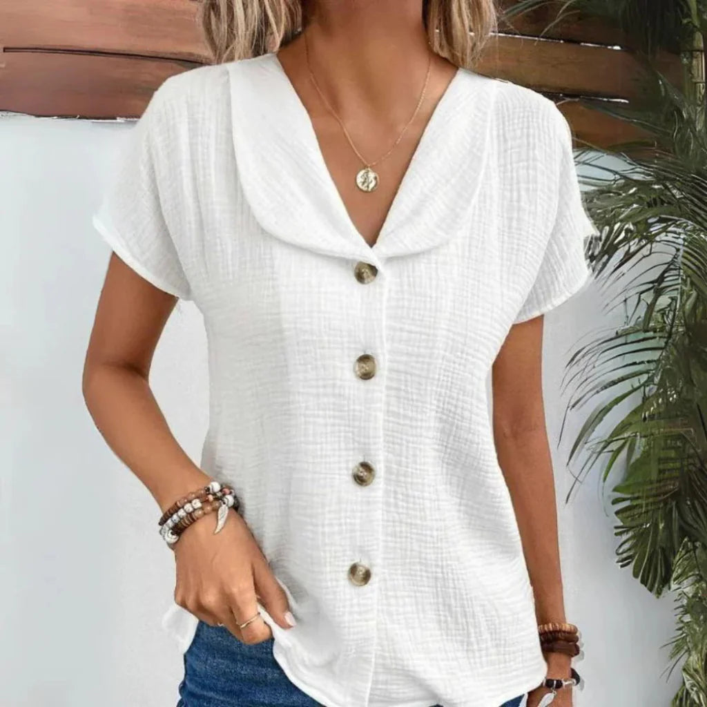 Chemisier femme élégant à col boutonné, parfait pour le bureau ou une tenue quotidienne raffinée au printemps/été.