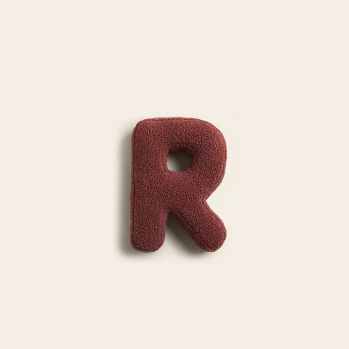 Coussin personnalisé R, doux et décoratif, idéal pour salon ou chambre à coucher.