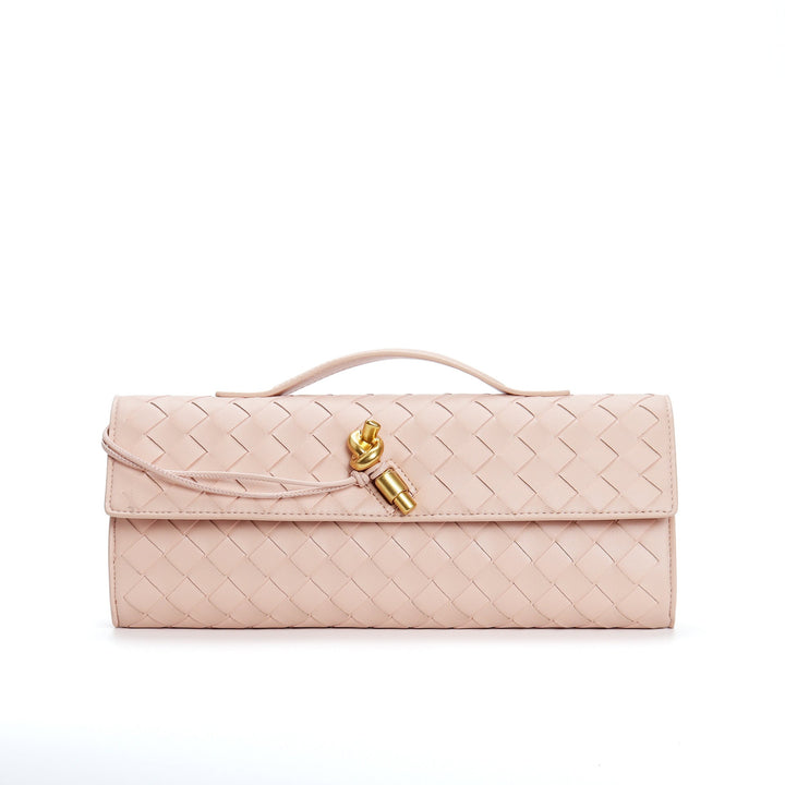 Sac à main en cuir tressé noir, porté par une femme, style élégant.