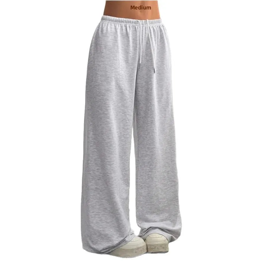 Vêtement femme: pantalon de jogging large, taille élastique, cordon. Parfait pour le sport ou un look décontracté.