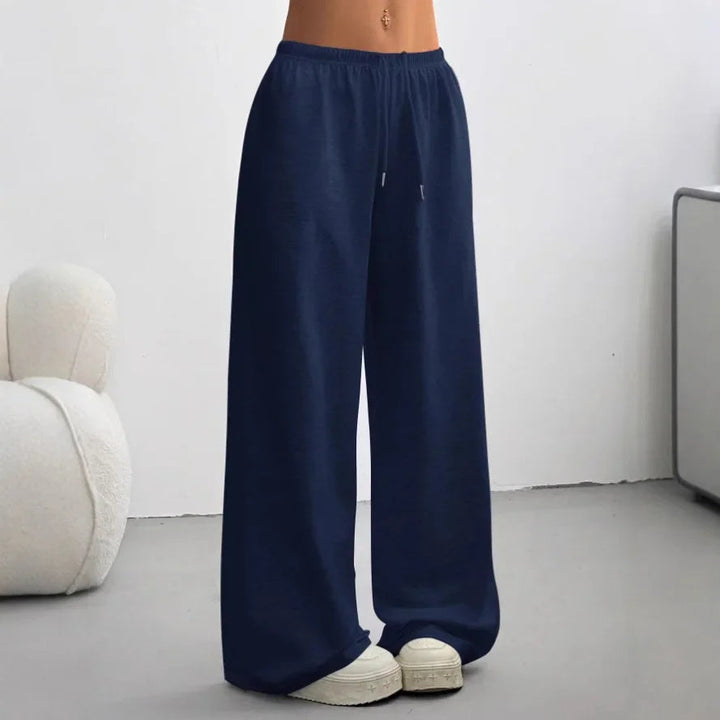 Pantalon large femme sportswear, taille élastique avec cordon de serrage. Jambes amples pour un confort optimal.
