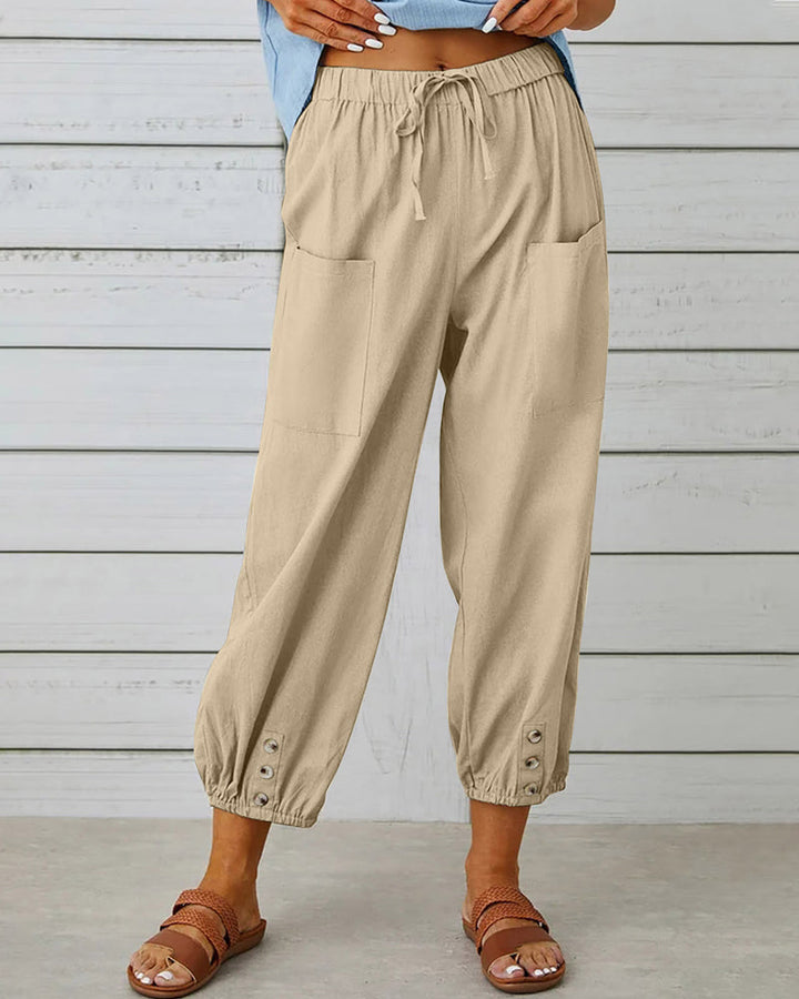 Mode femme : pantalon sarouel décontracté avec boutons décoratifs et taille élastique. Idéal printemps/été.