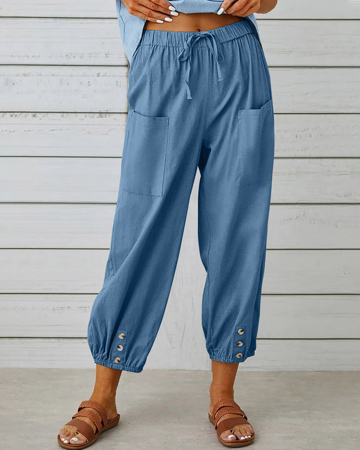Pantalon sarouel femme moderne, coupe ample et décontractée. Boutons stylés, taille élastique. Idéal mode casual.