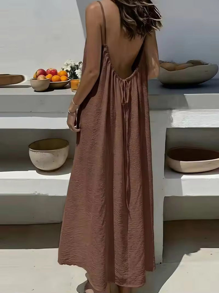 Robe d'été maxi femme fluide et ample, avec bretelles fines, dos ouvert. Parfaite pour une allure décontractée.