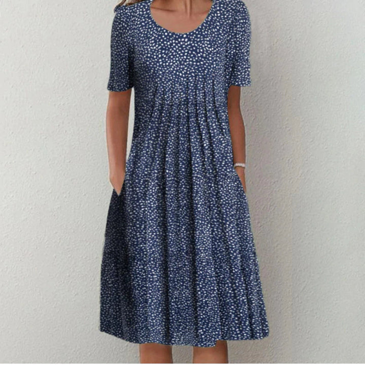 Robe midi fluide fleurie femme, coupe décontractée et élégante. Parfaite pour le printemps/été, avec poches.