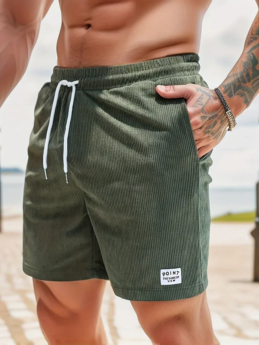 Maillot de bain homme côtelé noir, confortable et ajustable, parfait pour vos vacances à la mer.