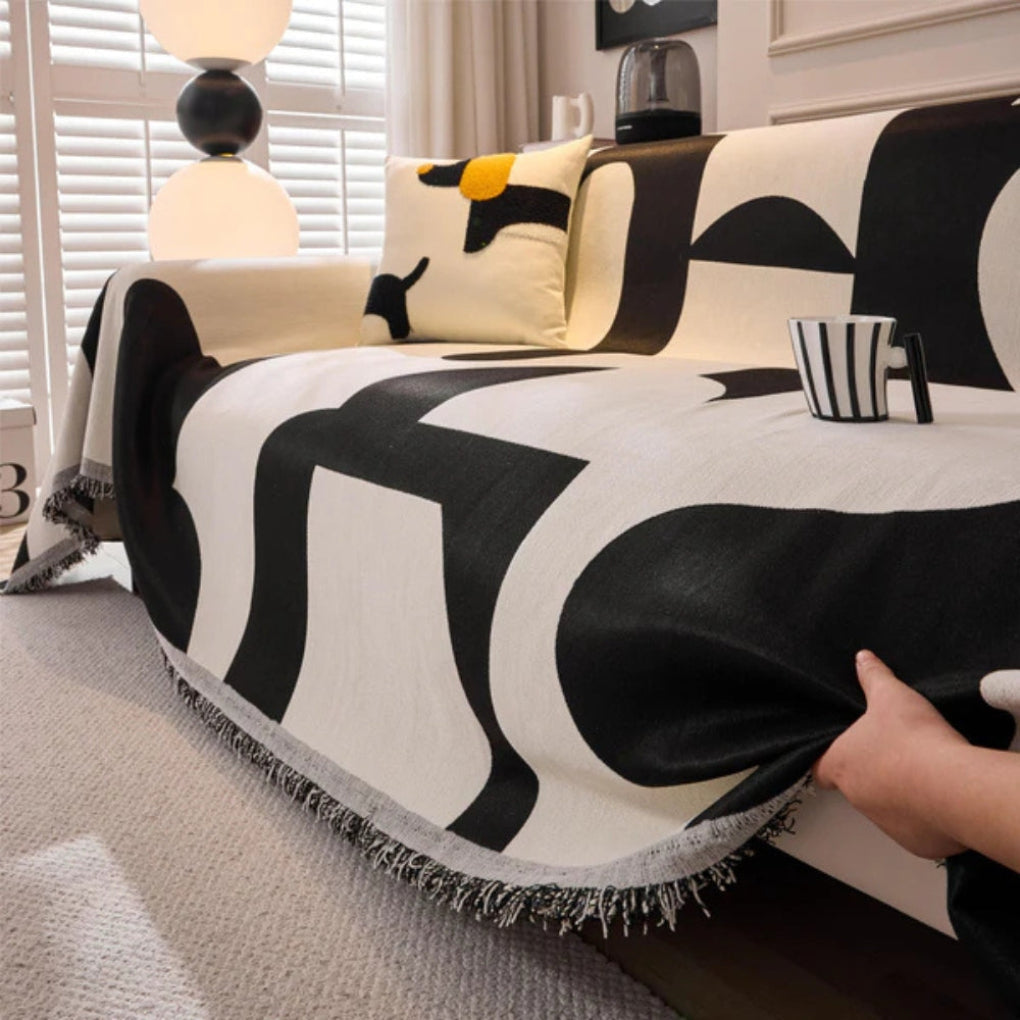 Accessoire maison : housse de canapé géométrique, style bohème, protection et élégance pour votre salon.