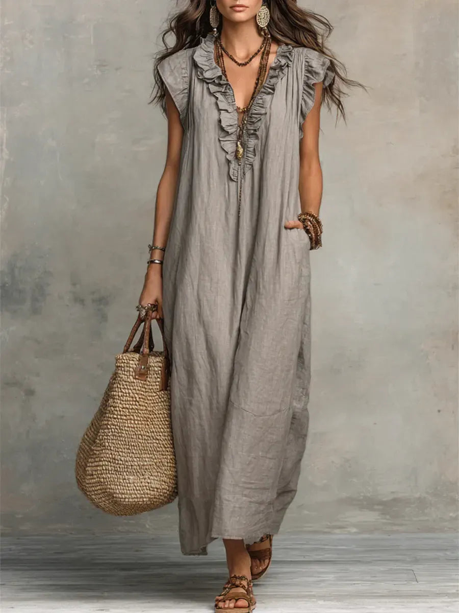 Robe longue fluide pour femme avec volants et poches pratiques, sans manches. Style élégant pour l'été.