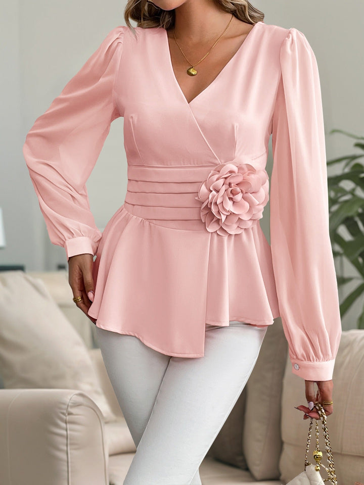 Chemisier femme à manches bouffantes, fleurs 3D, coupe péplum. Tendance mode féminine pour bureau ou occasions.