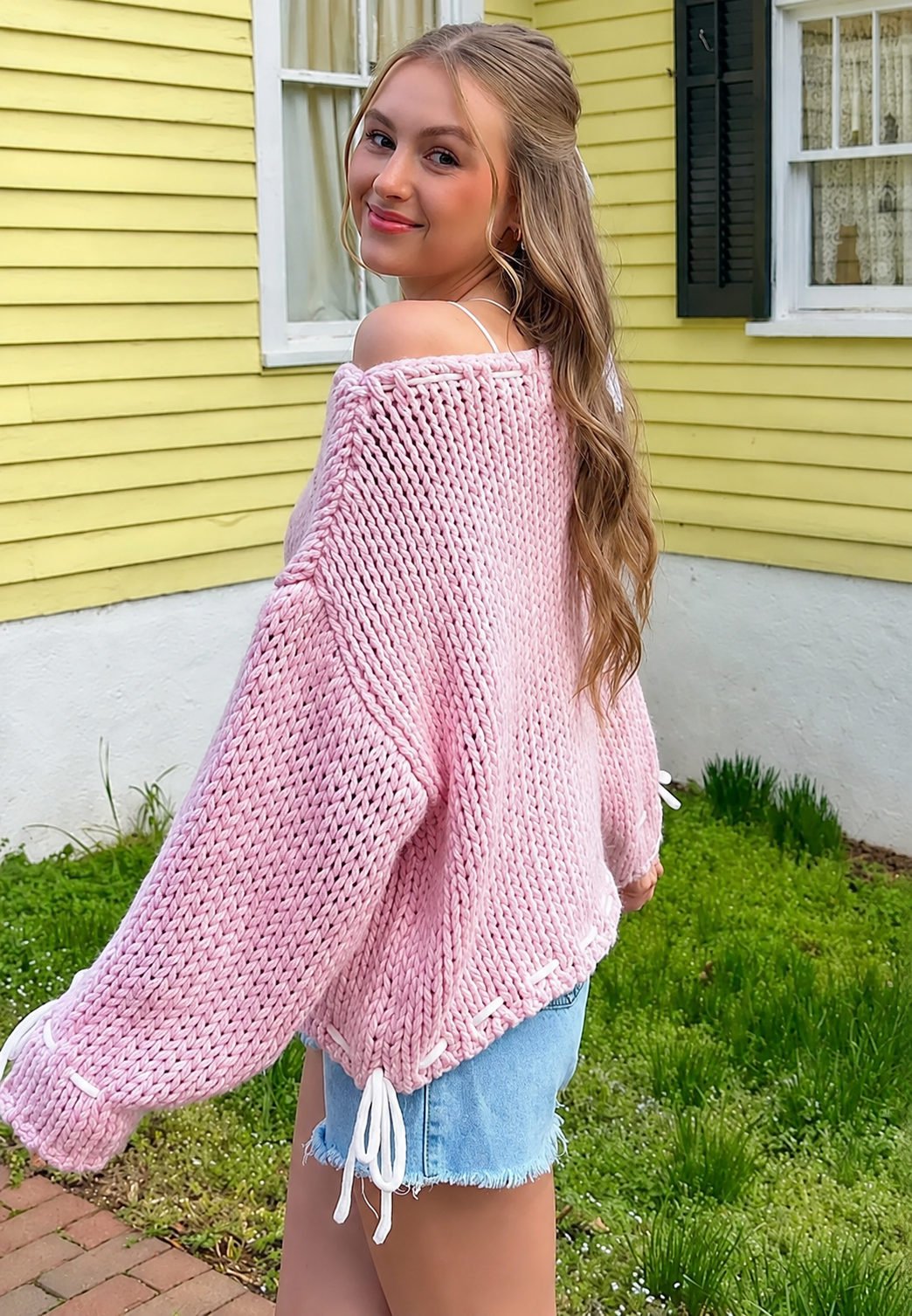 Pull femme élégant, col bateau, nœuds décoratifs. Manches longues, confortable pour un style hivernal.
