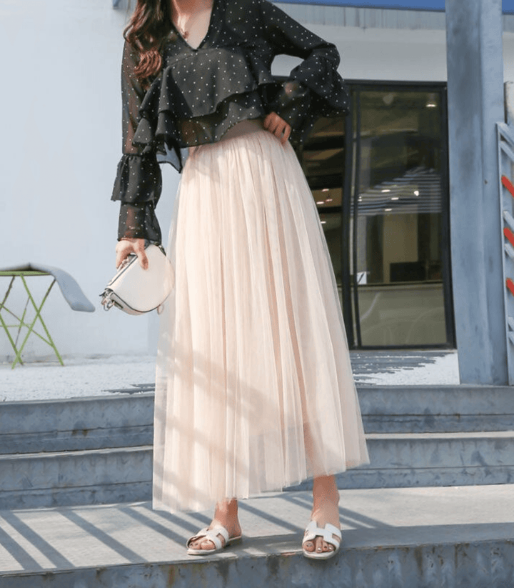 Jupe midi fluide rose pour femme, offrant un confort absolu et une élégance décontractée. Idéale été.