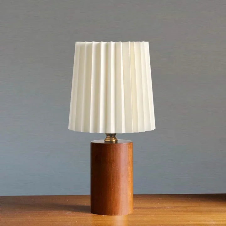 Élégante lampe de table nordique. Abat-jour plissé, base en bois naturel. Design minimaliste pour une lumière douce.
