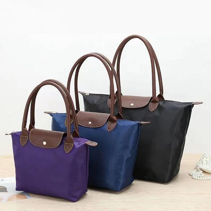Sac de transport femme durable et élégant. Fait de nylon et cuir résistant à l'eau, un fourre-tout mode essentiel.