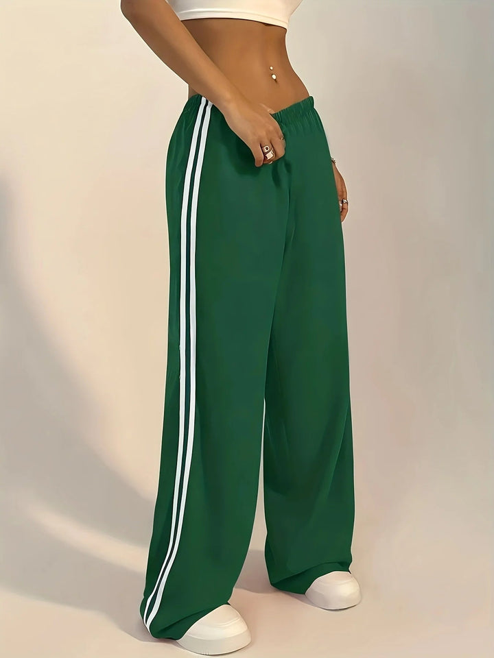 Femme portant un pantalon de survêtement ample et confortable, parfait pour le sport ou la mode décontractée.