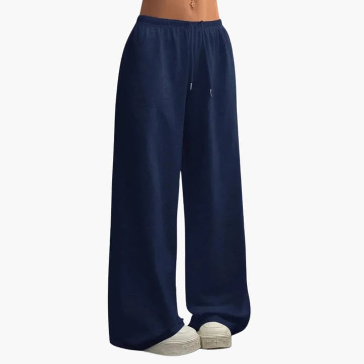 Modèle de pantalon large femme, taille élastique, alliant confort et élégance. Style ample et féminin décontracté.