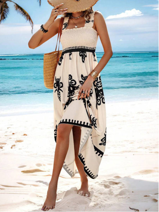 Robe longue décontractée femme, smockée, fluide, avec ourlet asymétrique. Parfaite pour l'été.