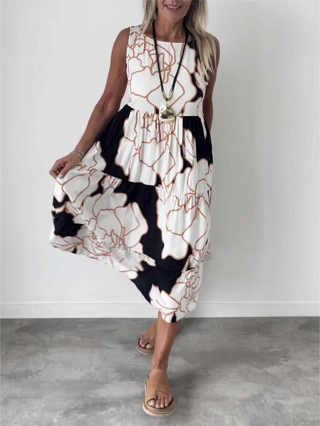 Robe midi trapèze fleurie élégante pour femme, sans manches, parfaite pour l'été et les occasions chic. Fluide et confortable.