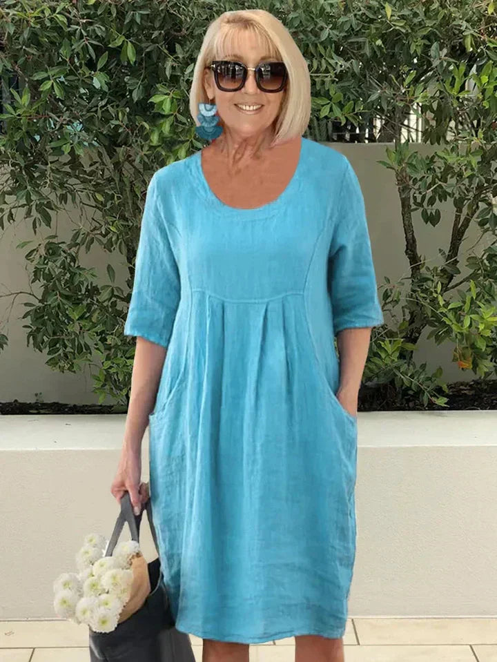 Robe midi trapèze élégante pour femme, couleur unie, coupe fluide avec poches pratiques. Parfaite pour toute occasion.