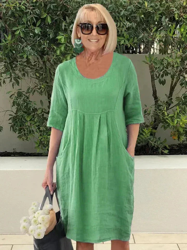 Robe midi trapèze femme, tissu doux et fluide, élégante et confortable avec poches. Robe polyvalente pour la saison.