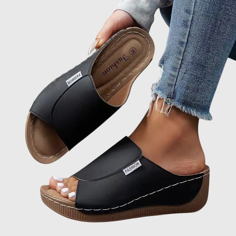 Pieds de femme portant des sandales compensées confortables et élégantes, parfaites pour l'été. Style décontracté.