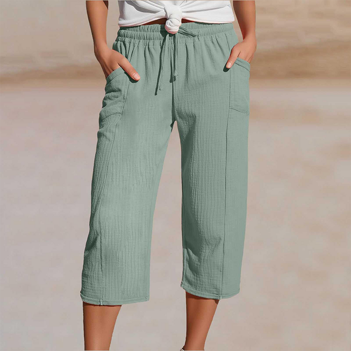 Pantalon cropped femme en coton lin, taille élastique, coupe décontractée pour l'été.