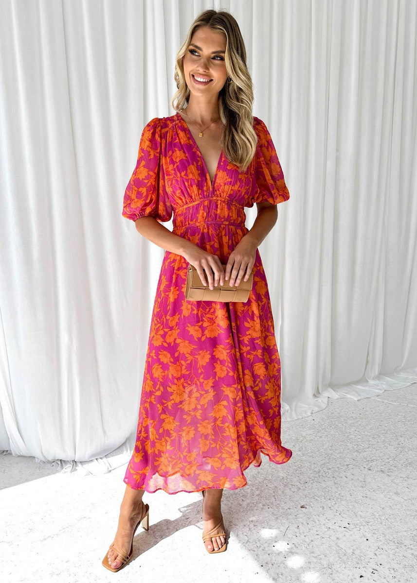 Robe midi fleurie femme avec manches bouffantes et col en V, parfaite pour un style printanier chic et élégant.